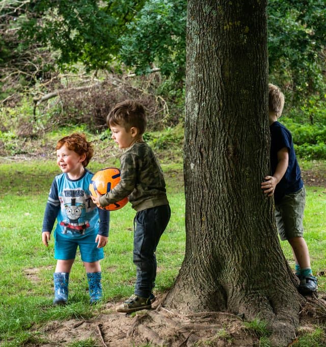 Children playing outdoors with a ball