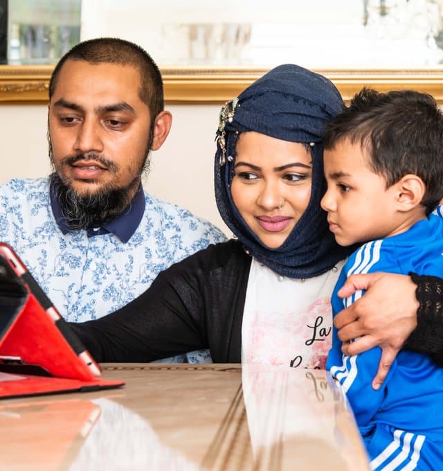 Family looking at tablet