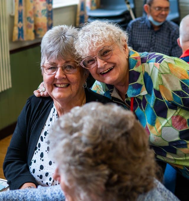 Two older ladies smiling