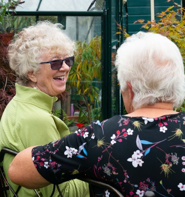 Two elderly ladies talking